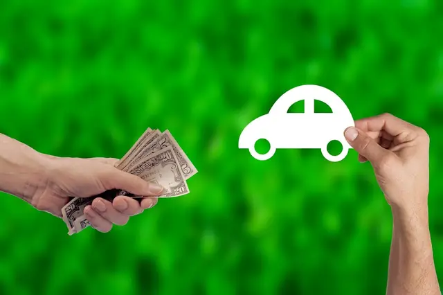 Cash and model car in hands