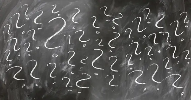 A person looking confused with question marks around their head.